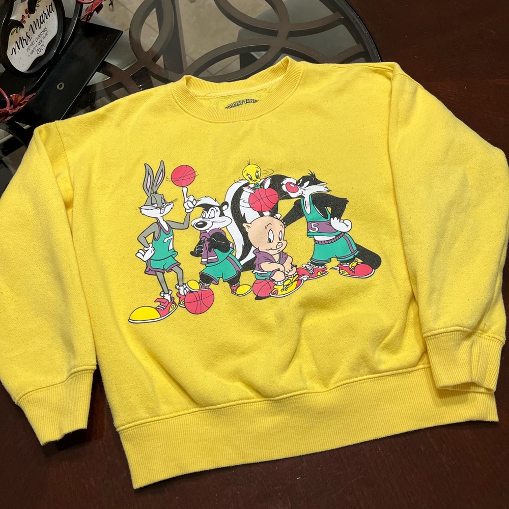 - - - Unisex Looney Tunes Sweatshirt.  Yellow sweatshirt featuring a fro…